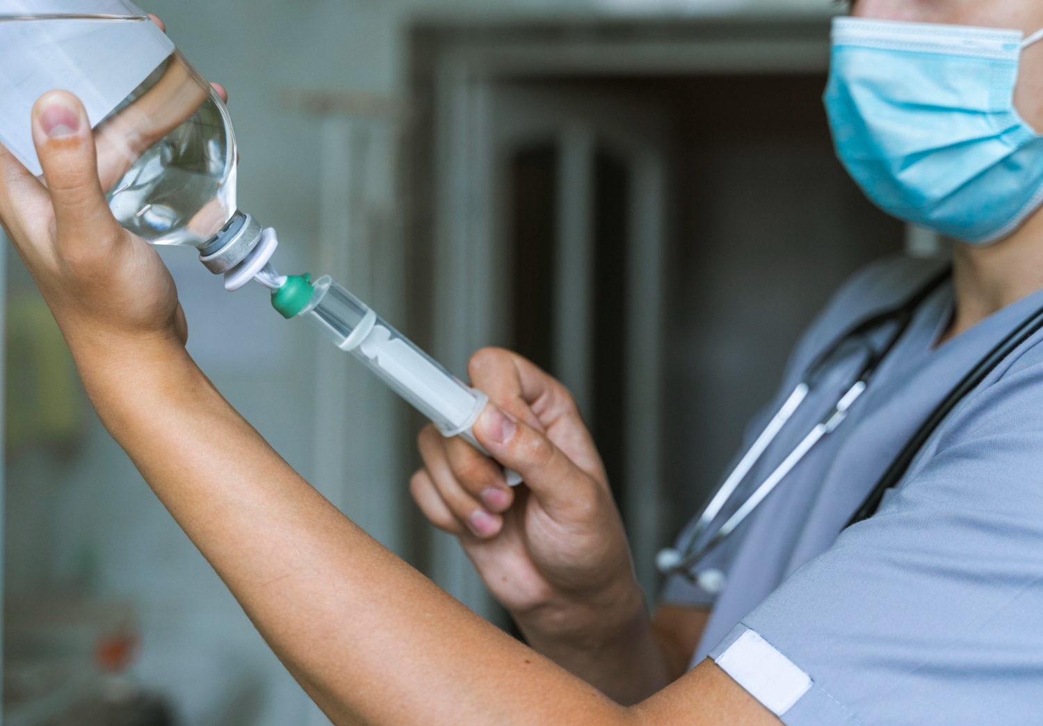A nurse administering IV therapy